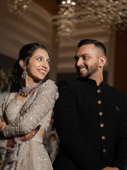 A joyful, candid shot of the couple looking at each other and smiling during their reception. Their happiness is infectious.