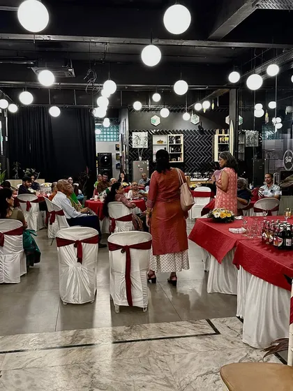 Another view of an indoor event, with guests enjoying the comfortable seating and modern ambiance.