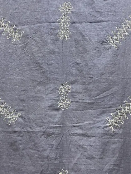 A different angle of the Sashiko-embroidered saree, highlighting the texture of the cotton fabric and the delicate white threadwork.