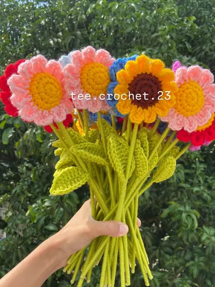 A handful of colorful stuffed daisy flower stems, perfect for a cheerful bouquet.