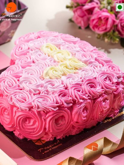 Sometimes, the most romantic gesture is a classic. This heart-shaped cake, covered in beautiful pink rosettes, is a timeless way to say "I love you."