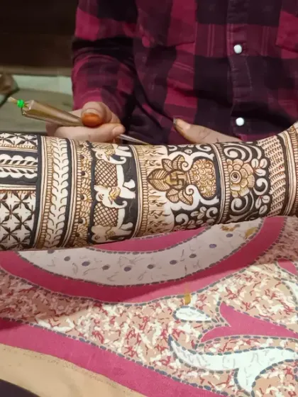 A close-up of me applying an intricate floral and paisley design. A steady hand is key to achieving this level of detail.