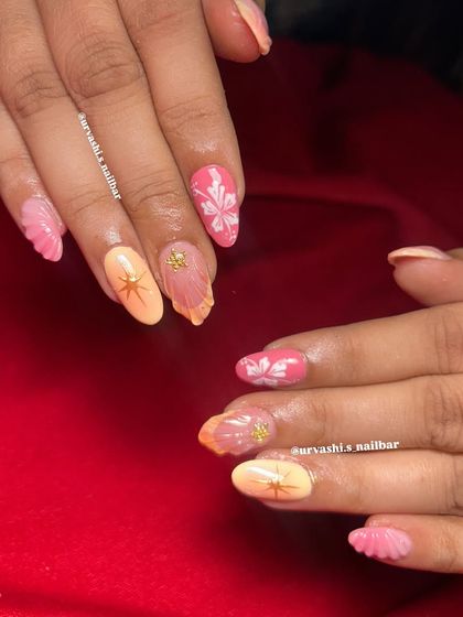 This trendy set combines multiple elements for a fun, summery vibe. It features sculpted shells, hand-painted florals, and starburst accents in a warm pink and orange color palette.