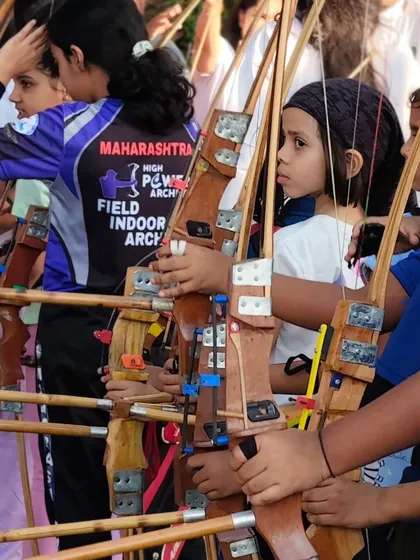 A line of young archers, bows in hand, ready for their turn. The future of Indian archery starts right here.