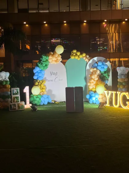 A sweet and simple baby elephant theme for Yug's first birthday. This outdoor setup uses a soft color palette and arched backdrops.