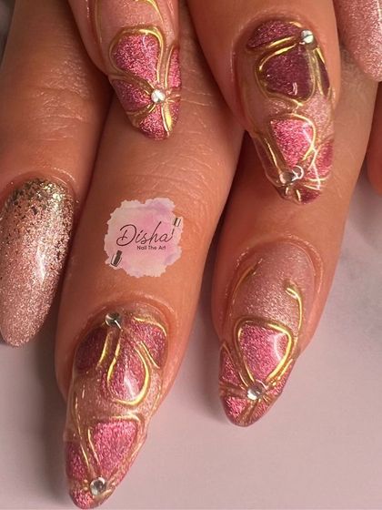 A beautiful and intricate design with pink cat eye, gold outlines, and delicate jewel accents.