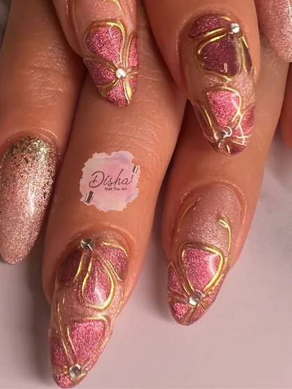 A beautiful and intricate design with pink cat eye, gold outlines, and delicate jewel accents.