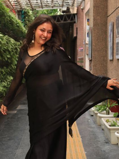 A joyful, twirling motion in my black saree. I love outfits that have great movement and flow, especially for events with dancing.