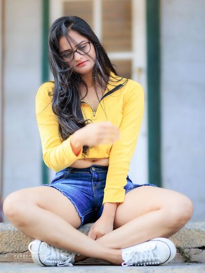 A candid-style shot with her hair blowing in the wind. This portrait feels free, natural, and full of life.