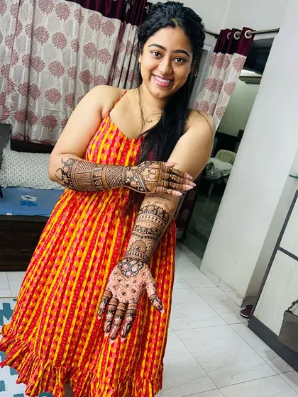 A happy bride showing off her full bridal mehendi. Seeing my clients this happy with the final result is the best part of my job.