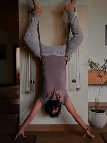 Another angle of the inverted aerial pose, showcasing the full-body engagement required to maintain stability and alignment.
