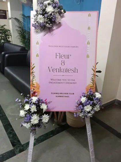 A personalized welcome sign for Fleur and Venkatesh's engagement ceremony. The sign is decorated with beautiful fresh flower arrangements to greet guests as they arrive.