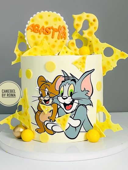 A cake celebrating the timeless friendship and mischief of Tom and Jerry. I used edible prints for the characters and surrounded them with fun, cheesy details for Agastya's 3rd birthday.