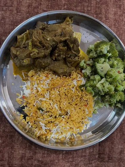 A balanced plate of mutton curry, biryani rice, and steamed broccoli. Sticking to foods I enjoy is the key to long-term consistency.