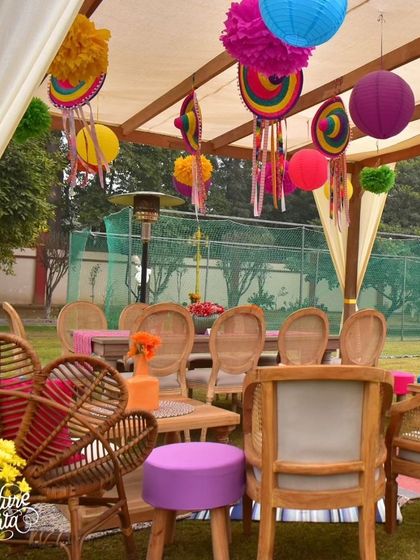 Another view of the lounge seating, showing a mix of wicker and wood furniture with colorful accents.
