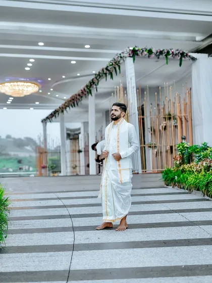 The groom looking sharp at the 'Muhurtam'. We designed the entrance with a simple yet elegant floral arch to welcome guests to the wedding ceremony.