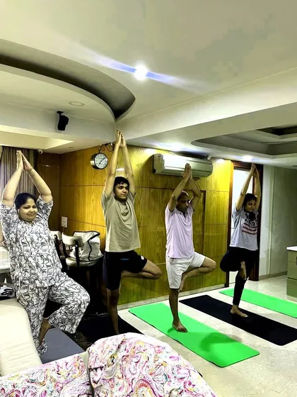 A full view of the group at Vidhilakshi Foods, all engaged in Vrikshasana. It's wonderful to see teams embrace wellness together.