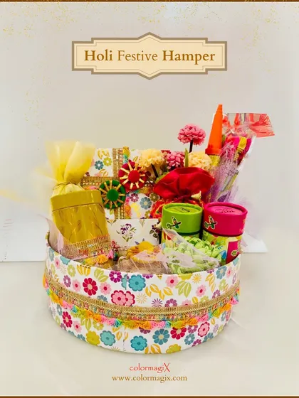 A round floral box filled with Holi goodies. This festive hamper is a beautiful and compact gift, perfect for sharing the colors and joy of the season.