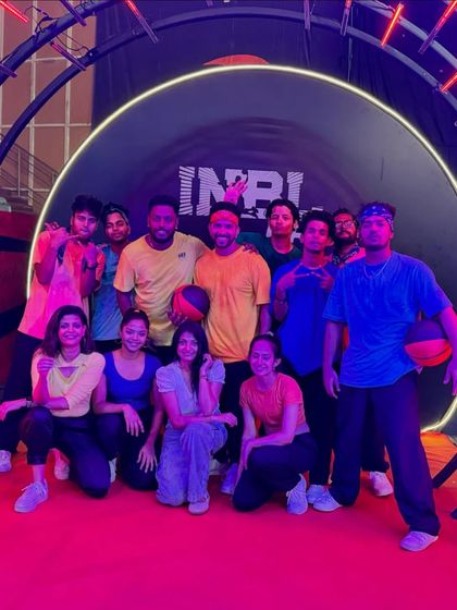 A fun group photo with the team at the INBL event entrance. We believe in working hard and celebrating our successes together.