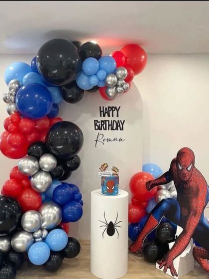 A modern Spider-Man theme with a stylish balloon arch and a large character cutout, perfect for a photo booth.