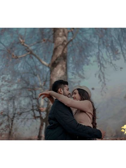 A loving hug with the beautiful, sparse trees of Kashmir in the background. This shot feels serene and deeply romantic.