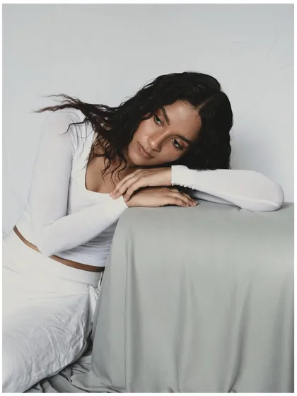 A pensive and gentle portrait. The model's head resting on her arms creates a feeling of introspection and calm. This pose is great for conveying a softer, more emotional side.