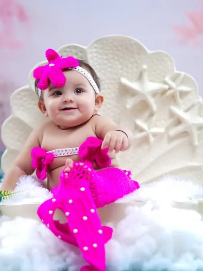 This little one is pretty in pink, dressed as a mermaid for her milestone photoshoot.