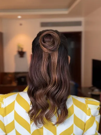 A back view of the half-updo with a unique circular bun, showcasing a creative and artistic hairstyle.