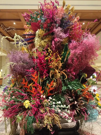 To celebrate Holi, the festival of colors, I created this explosive, multi-hued floral sculpture. It’s a riot of dried and fresh flowers in every imaginable shade, from vibrant pinks and oranges to surprising pops of blue and yellow. This installation is my ode to joy, a reminder to embrace life with an open heart. Bura na mano, Holi hai!