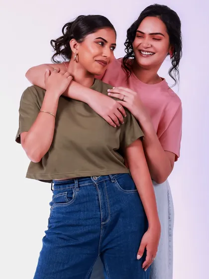 A warm and affectionate pose that tells a story of friendship. The soft lighting and simple outfits create a timeless and relatable portrait.