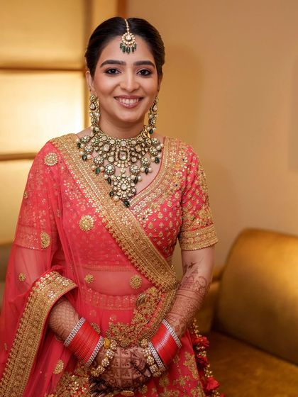 A full-length view of this stunning bride. The makeup, hair, and outfit combine to create a look that is both traditional and effortlessly elegant.