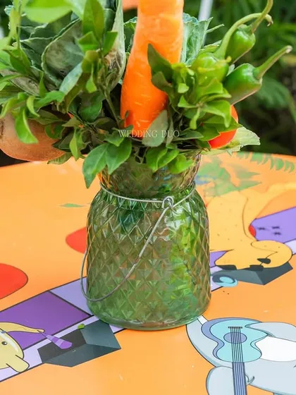 We believe in playful details. For this festival-themed Mehendi, we used fresh vegetables like carrots and chilies in our centerpieces, adding a quirky and sustainable touch to the colorful tables.