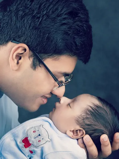 A father's gentle love for his sleeping newborn. A quiet, powerful portrait of fatherhood.