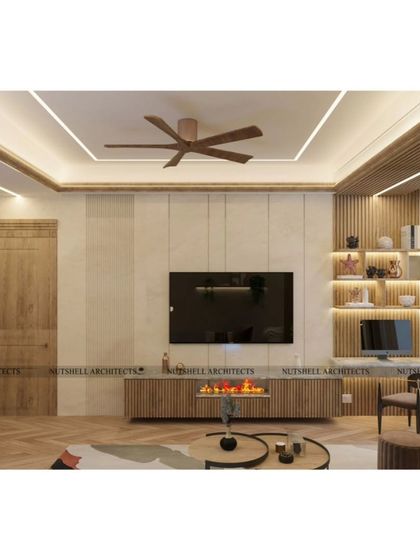 This convertible room features a TV lounge setup with an integrated fireplace for a cozy ambiance. The use of vertical wood slats and back-lit shelving adds warmth and character to the minimalist design.