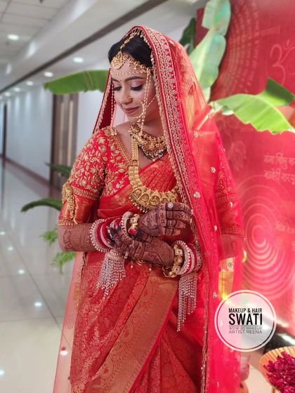 A candid moment of Kshitija during her wedding ceremony. Her embroidered red saree and jewellery look absolutely stunning.