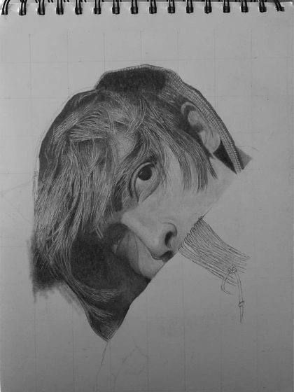 An early stage of a self-portrait. You can see the grid lines and the initial shading of the eye and hair, the first steps in a long process.