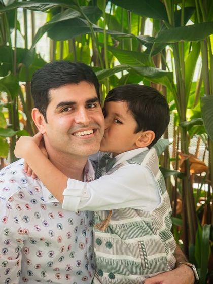 A heartwarming moment between father and son during the birthday festivities. A sweet kiss on the cheek is a memory to be treasured.