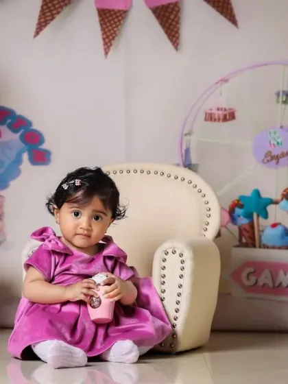 Sitting pretty in the candy land theme, complete with a mini milkshake prop.