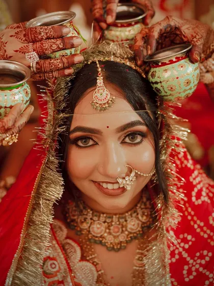 A close-up during a wedding ritual, highlighting the bright, beautiful eyes and flawless makeup.