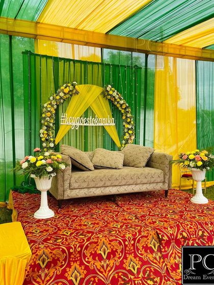 A fresh green and yellow theme for an outdoor Mehndi ceremony. I created a floral semi-arch with a custom hashtag sign, making it a personalized photo spot for the couple.