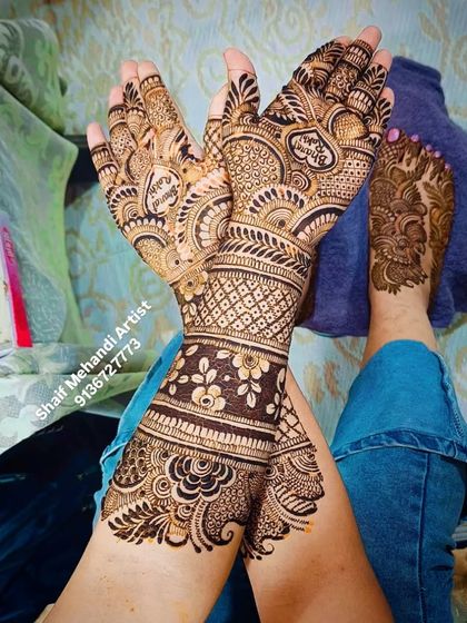 A complete bridal look, showing how the feet mehandi can be coordinated with the hand designs for a cohesive look.