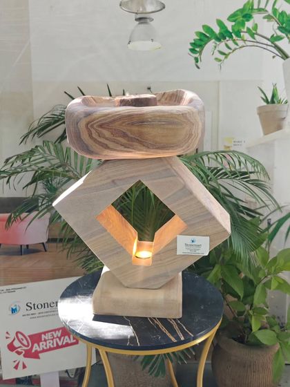 A full view of the modern lamp and fountain combination, showcasing its unique design and the beautiful wood-like grain of the Teak Sandstone.