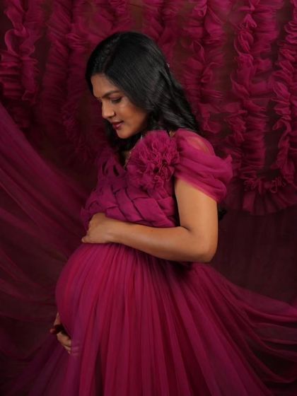 Another angle of the stunning magenta maternity gown, showing how the flowing fabric can be used to create an artistic and romantic backdrop for your portraits.