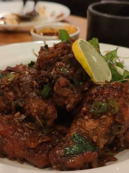 A close-up of our spicy chicken, tossed in a rich sauce with fresh herbs and a squeeze of lemon. This dish is perfect for those who enjoy bold and fiery flavors.