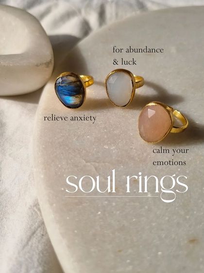 My soul rings collection. This image features rings in Labradorite to relieve anxiety, White Moonstone for abundance and luck, and Rose Quartz to calm your emotions.