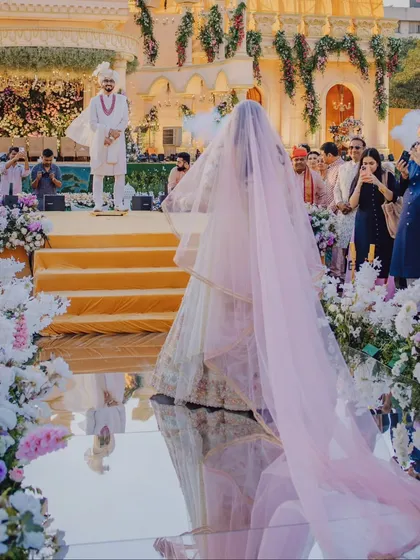 The bride's grand entrance down a mirrored aisle, reflecting her every step towards her future. This is a moment of high emotion and anticipation that we capture with an artistic eye.