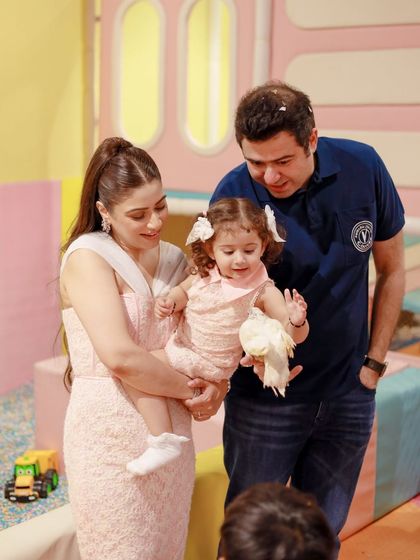 A family is captivated by a magic trick involving a live dove. This entertainment add-on brings a sense of wonder to any party theme, including this barnyard bash.