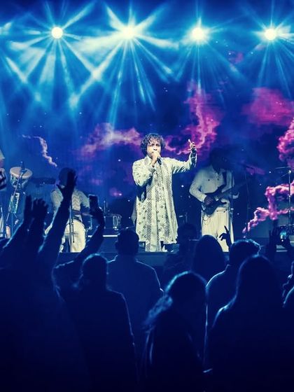The view from the front row at DKS Club. The stage is alive with lights and sound, and the audience is completely immersed in the Sufi rock experience.