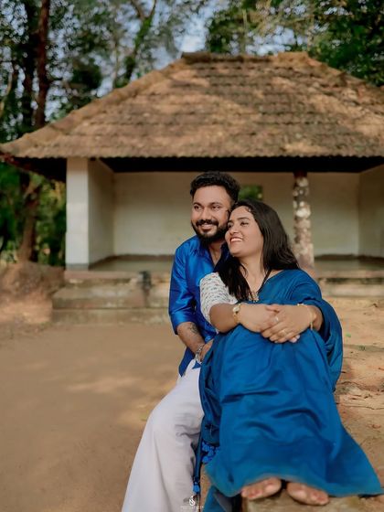 A cozy moment in front of a traditional hut. This location near Puttur is perfect for couples wanting a rustic and authentic photoshoot.