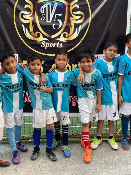 Our youngest players posing for a photo at their first tournament. The start of many adventures together.